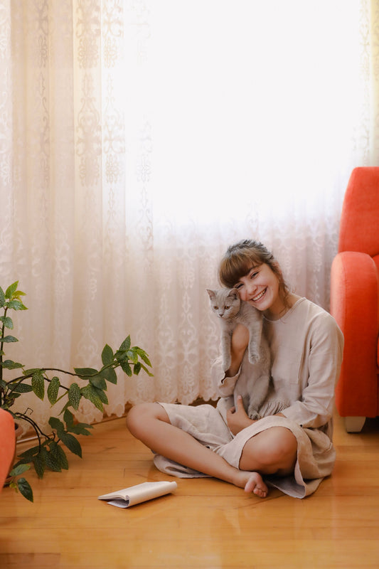 Cat parent with her cat in a bright living room